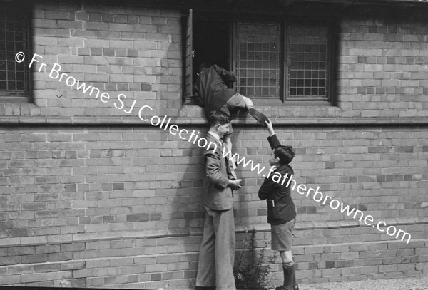 MAN AND BOYS AT WINDOW